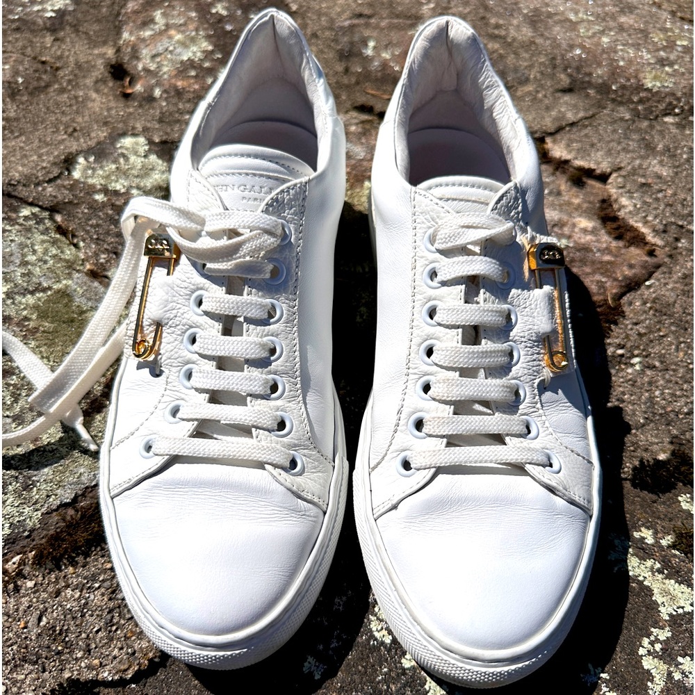 John Galliano Paris women’s white leather sneakers with gold pin.